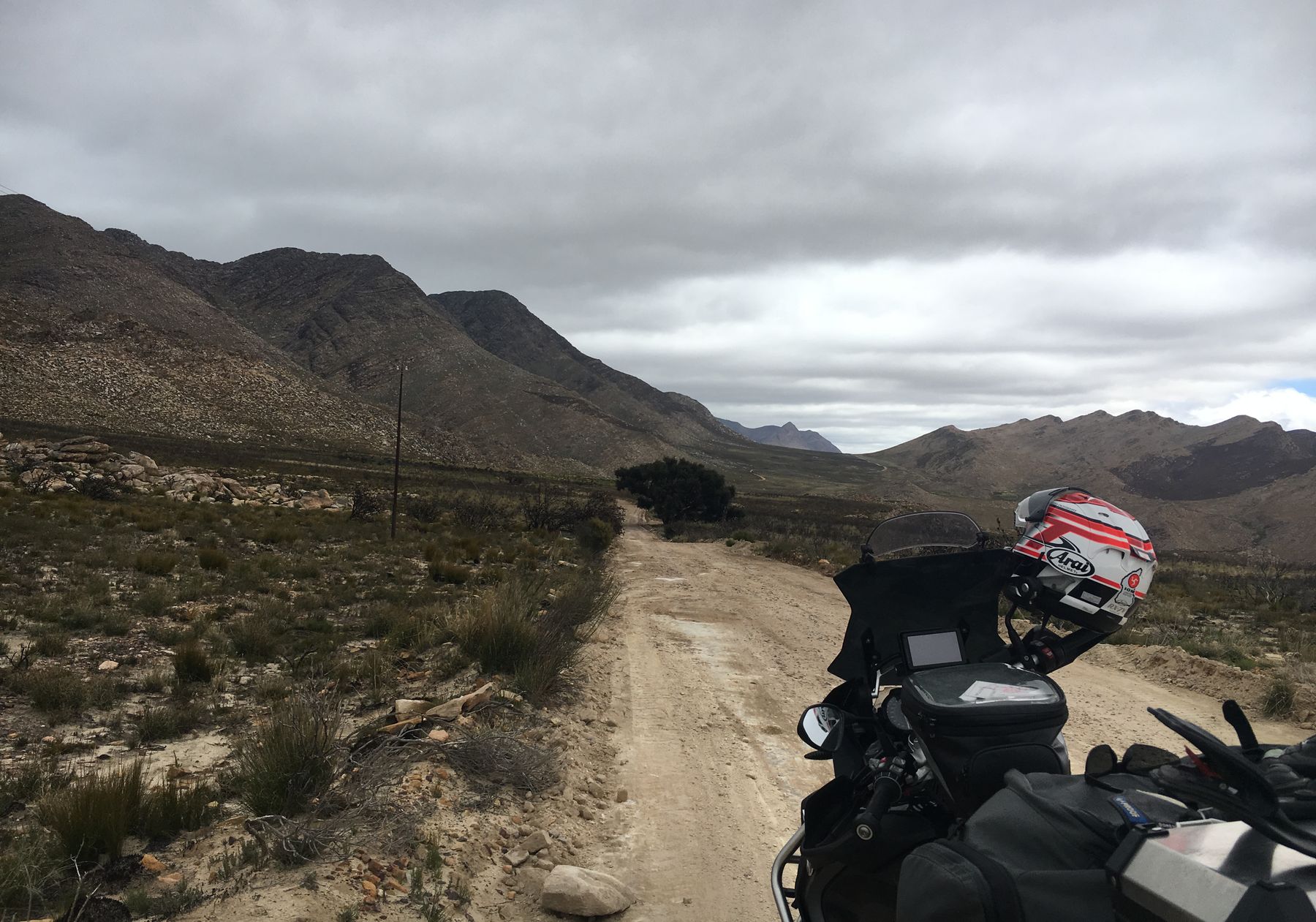 Motorcycle on a gravel road through the Swartberg mountains, South Africa