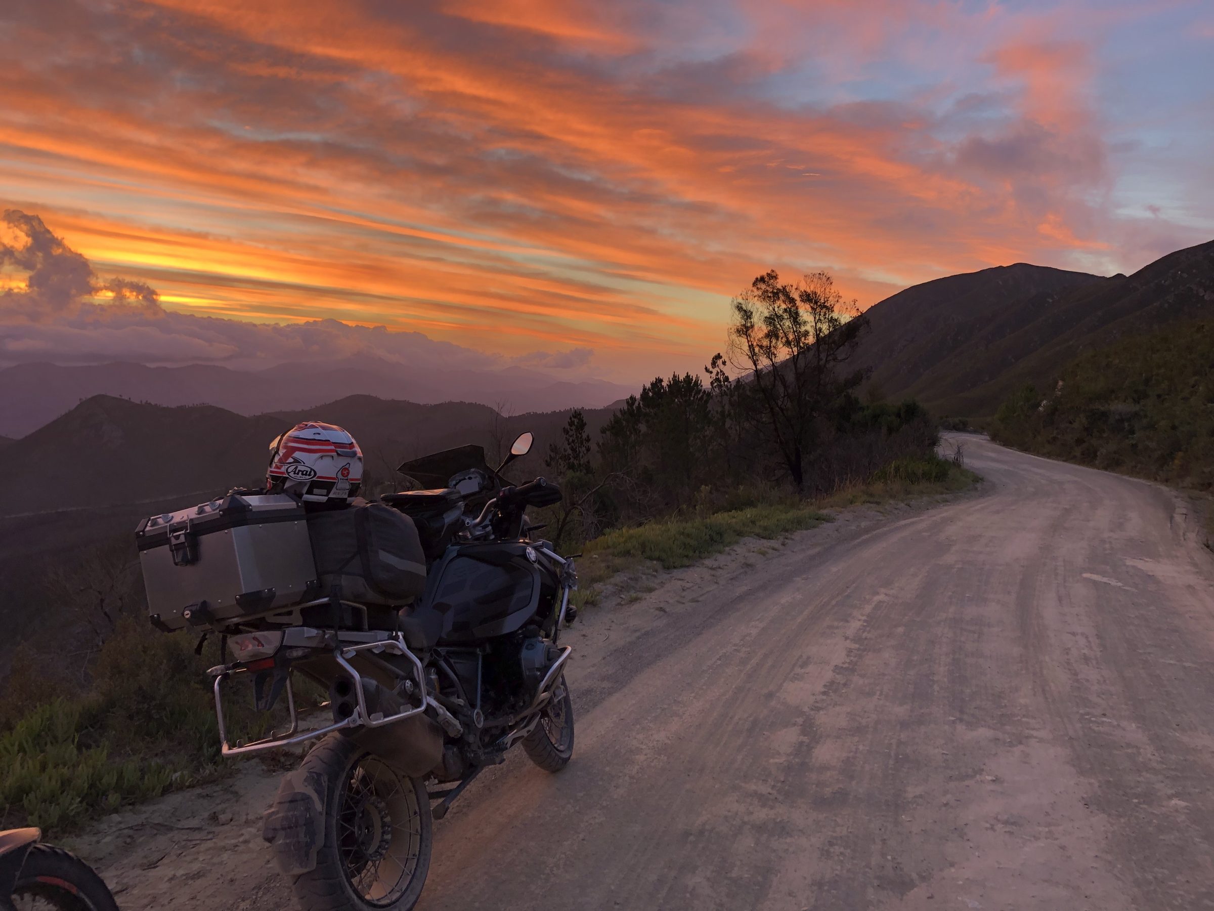 Motorcycle on a gravel road at sunset in the Western Cape, South Africa, on a guided motorcycle tour